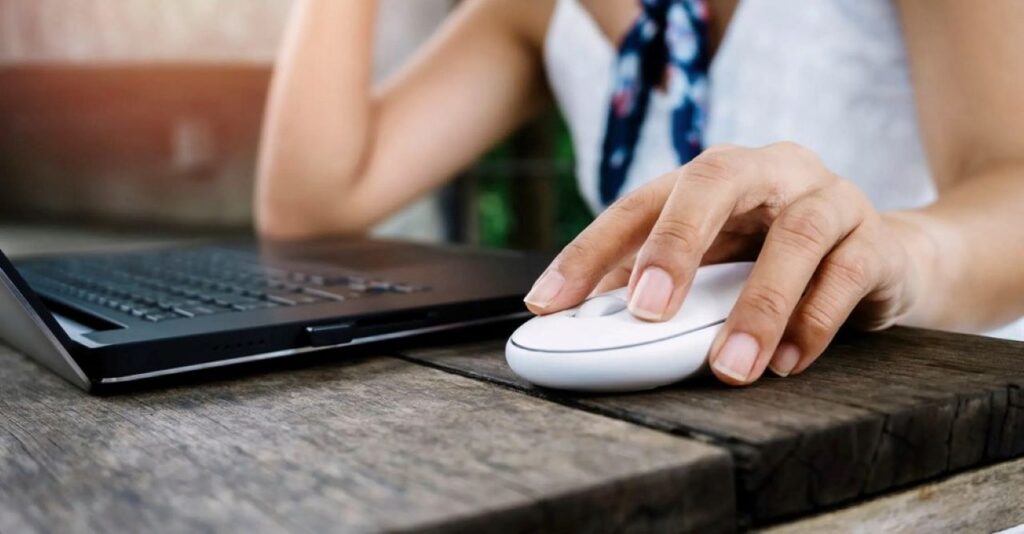 the man is holding a wireless mouse 